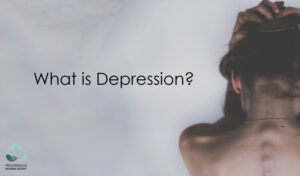 what is depression? woman facing away from point of view with hands over her head