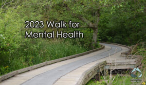 Decorate text for the 2023 Mental Health Walk over the wood walkway of deer lake